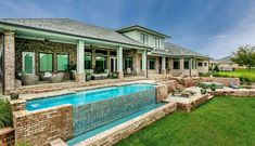 a house with a swimming pool in the front yard and patio area next to it