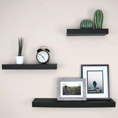 three black shelves with pictures and an alarm clock