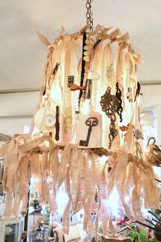 a chandelier hanging from the ceiling in a room with many items on it