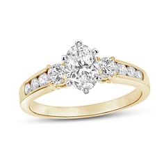 a yellow gold engagement ring with three stones