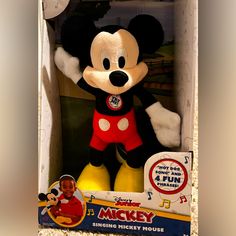 a mickey mouse stuffed animal in a box