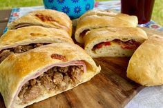 some meat and cheese pastries on a cutting board