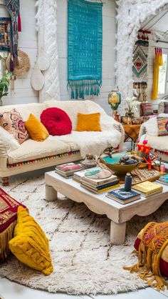 a living room filled with lots of furniture and pillows on top of a white rug