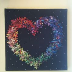 a heart made out of puzzles on a black background