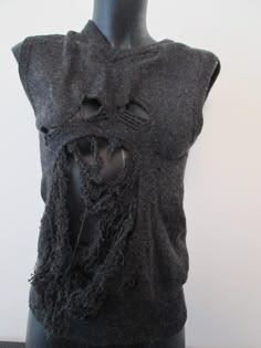 This unique piece of clothes is a second hand vest sweater that has been 'de-knitted' at some parts and re-knitted differently by hand, in a 'grungy-destroyed' way, using ancient artisanal techniques of repairment. It is size 36 FR and also convenient for a 34 FR and a 38 FR. It is pure lambswool, mottled dark grey color. Fitted Grunge Vest For Fall, Knitted Crew Neck Vest, Knit Sweater Vest With Crew Neck For Fall, Crew Neck Knit Sweater Vest For Fall, Fall Crew Neck Knit Sweater Vest, Knitted Crew Neck Vest For Fall, Fall Knitted Crew Neck Vest, Fall Crew Neck Knitted Vest, Knit Crew Neck Sweater Vest