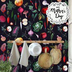 a kitchen wall covered in colorful vegetables and cooking utensils