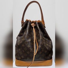 Gorgeous Lv Bucket Bag! Vintage 1993 Exterior Lv Monogram Canvas Body Vachetta Leather Trim, Bottom, And Strap - Conditioned Gold Tone Hardware Throughout - Recently Cleaned Removable/Adjustable Strap (11.25-13.75 Drop Approx) With Gold Tone Buckles. Authentication Number Behind One Of The Strap Handles Interior Canvas Lining In Tan - Near Excellent Condition Key Latch Ring Callouts Typical Of Lv Vachetta Leather, The Leather Of The Trim And Straps Have Begun To Crack. The Leather Has Been Clean Pre-owned Brown Monogram Canvas Bag, Vintage Brown Bucket Bag For Shopping, Vintage Brown Monogram Canvas Shoulder Bag, Vintage Monogram Canvas Shoulder Bag For Formal Occasions, Formal Vintage Shoulder Bag In Monogram Canvas, Formal Vintage Monogram Canvas Shoulder Bag, Classic Bucket Bag In Monogram Canvas, Vintage Brown Monogram Canvas Bags, Formal Brown Monogram Canvas Bucket Bag