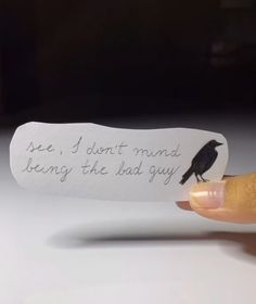 a hand holding a piece of paper with a bird on it that says, i don't mind being the bad guy