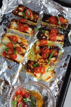 some food is sitting on tin foil and ready to be cooked in the oven or grill