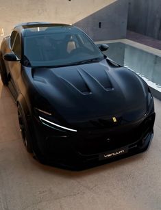 a black sports car parked in front of a building