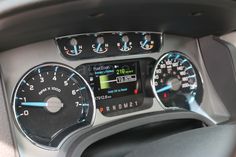 the dashboard of a car with speedometers and other gauges