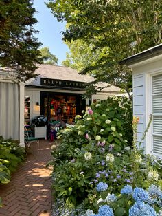 a garden store with lots of flowers and plants in it's front yard area