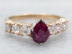 Add some sparkle to your life with this ring! Featuring a stunning pear cut ruby and diamond accents, this yellow gold ring is perfect for any occasion. Shine bright with this unique piece that will definitely turn heads! Metal: 14K Yellow GoldGem: Ruby 1.08 CaratsGem Measurements: 5.5 x 7.3 mm, Pear CutAccents: 6 Diamonds totaling .82 Carats, SI in Clarity, G-H in ColorRing Size: 7Marks: "14K" Stamped on the inside band Diamond Ruby Ring With Prong Setting In Pear Shape, Pear-shaped Ruby Ring With Diamond, Pear-shaped Ruby Diamond Ring With Prong Setting, Yellow Gold Ruby Ring With Prong Setting, Pear-shaped Ruby Ring In Yellow Gold With Prong Setting, Pear-shaped Yellow Gold Ruby Ring, Pear-shaped Brilliant Cut Yellow Gold Ruby Ring, Yellow Gold Pear-shaped Ruby Ring With Center Stone, Pear-shaped Yellow Gold Ruby Ring With Center Stone