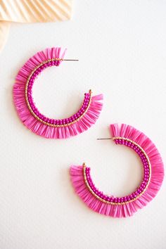 The Gracie Rattan Fan Hoops are the perfect accessory to elevate your tropical vacation style. These colorful rattan hoop earrings exude a playful and vibrant charm that complements any summertime outfit. Handcrafted with intricate attention to detail, each earring features a unique fan-shaped design, adding a touch of whimsy and exotic flair. Made from sustainable rattan material, these lightweight hoops provide a comfortable fit without compromising on style. Whether you're strolling along the Handmade Hoop Earrings For Summer Vacation, Pink Bohemian Hoop Earrings For Beach, Pink Bohemian Beaded Earrings For Vacation, Pink Beaded Earrings For Beach, Pink Beaded Earrings For The Beach, Pink Fun Hoop Earrings, Fun Pink Hoop Earrings, Trendy Pink Earrings For Vacation, Beaded Pink Hoop Earrings For Beach