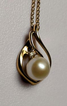 Beautiful 18k yellow gold tear drop pendant with a pearl and diamond. Yellow gold 12K Gold Filled 16 inch chain. Approximate weight of 2 grams. Pendant is approximately 18 mm high and 9.5 mm wide.  Free shipping. Yellow Gold Teardrop Pearl Pendant Necklace, Yellow Gold Pearl Necklace With Teardrop Pendant, Teardrop Akoya Pearl Necklace, Yellow Gold Teardrop Necklace With Pearl Pendant, Gold Teardrop Pearl Necklace, Formal Yellow Gold Drop Necklace With Pearl Pendant, Elegant Yellow Gold Drop Necklace For Anniversary, Elegant Yellow Gold Pear Drop Necklace, Yellow Gold Teardrop Pearl Necklace