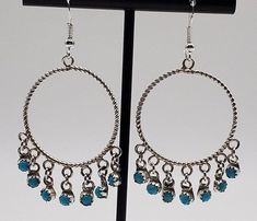 Gorgeous pair of turquoise studded, sterling silver hoop earrings!  These lovely earrings are hand crafted with beautiful round turquoise stones set in large sterling silver circles.  These beauties measure a full 2" in diameter and have sterling silver fringes set with turquoise stones which add an additional .5" making these dangle hoop earrings quite the stunners!  These big earrings easy to wear and are the perfect size to compliment any outfit and create a real statement piece.   These Nava Nickel-free Turquoise Circle Jewelry, Turquoise Sterling Silver Nickel-free Hoop Earrings, Turquoise Sterling Silver Round Hoop Earrings, Hypoallergenic Turquoise Sterling Silver Hoop Earrings, Turquoise Sterling Silver Small Hoop Jewelry, Nickel-free Turquoise Hoop Jewelry, Turquoise Hypoallergenic Round Hoop Earrings, Hypoallergenic Turquoise Round Hoop Earrings, Turquoise Hypoallergenic Hoop Earrings