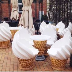 ice cream cones sitting on top of a brick patio