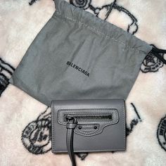 Balenciaga Trifold Compact Wallet In Gray Smooth Leather - Has A Snap Closure For Coins And Slot For Bills And Cards Great Condition - Gently Used Comes With Dust Bag Sold Out Everywhere!!! Retail Price Is $595 Open To Offers!!! Comes From A Smoke/Pet Free Home Designer Wallet For Everyday Use, Designer Bifold Bags With Interior Card Slots, Designer Bifold Bag With Interior Card Slots, Designer Clutch Wallet For Everyday Use, Designer Crossbody Wallets For Daily Use, Designer Travel Crossbody Wallets, Designer Travel Bifold Bag, Designer Bifold Coin Purse For Daily Use, Designer Wallet With Removable Pouch For Everyday Use