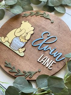 a wooden sign with the words baby's name and winnie the pooh on it