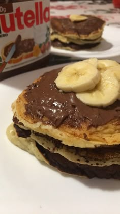 chocolate pancakes with bananas and nutella on top are ready to be eaten for breakfast