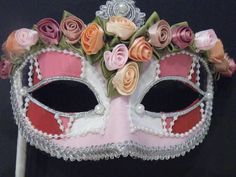 Handmade Venetian Masquerade mask covered in different shades of pink. Silver braid outlines each eye and pearls are found at the corner of each eye. The top of the mask is outlined by fabric flowers and the crown has a silver braid set by a pearl in the middle. the shadings are all separated by pearl beading. The mask is outlined with silver trim for an exquisite finish. Can come with a ribbon covered stick to hold from or tie back ribbons. This type of mask would look lovely on any Bride or br Pink Hatinator, Wedding Masquerade, Mask Flower, Venetian Wedding, Mother Of The Bride Hats, Mardi Gras Masquerade, Venetian Masquerade Masks, Masquerade Wedding, Kentucky Derby Fascinator