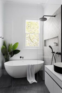 a white bath tub sitting next to a window