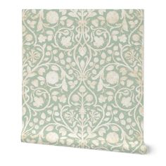 a green and white wallpaper with an ornate design on it's side,