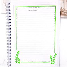 a notepad with green plants on it