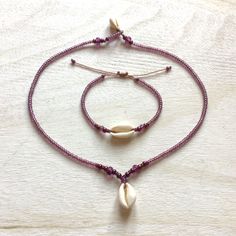 Jewelry made of natural cowrie shells (16 - 19 mm), lavender / purple color original Czech glass beads (3.1 / 4.1 / 5.6 mm Rocailles Preciosa) and waxed polyester cord (original Linhasita 1 mm). A necklace is available in 3 lengths (40 cm = 15.74 inches, 45 cm = 17.71 inches or 50 cm = 19.68 inches). The length of a bracelet is adjustable and should fit all wrists sizes.     The jewelry is robust and fully waterproof. If you have any questions/wishes, please don't hesitate to contact me! Handmade Purple Beach Jewelry, Purple Beaded Bracelets For The Beach, Purple Beaded Bracelets For Beach, Handmade Purple Necklaces For Beach, Handmade Purple Beach Necklaces, Adjustable Lavender Bracelets For Beach, Adjustable Lavender Bohemian Jewelry, Adjustable Bohemian Lavender Jewelry, Bohemian Adjustable Pink Shell Necklace