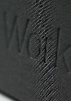 closeup of the word now written in black fabric