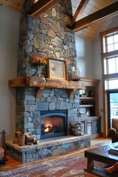 a living room with a fire place and stone fireplace