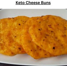 two cheese buns on a white plate with the words keto cheese buns