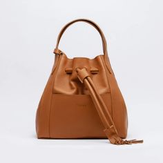 Material: Pebbled leather Color: Caramel Height: 30 cm 11.8 inch Length: 26 cm 10.8 inch Depth: 16 cm 6.3 inch Weight: 1.14 Kg 2.52 Lb. Sailor Bags, Arm Candy, Leather Handle, Pebbled Leather, Leather Purses, Drawstring Bag, Timeless Pieces, Bag Making, Bucket Bag