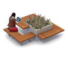 a person sitting at a table with a planter on it and a laptop in front of them