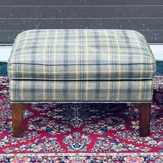 a foot stool sitting on top of a rug