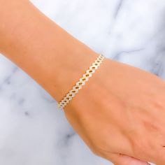 This distinctive 22k gold bangle blends reflective striped patterns in both yellow and white gold, offering a stunning visual contrast. With a gold weight of 12.8 grams and a size of 2.6, it features a bangle opening of 2.35 inches for ease of wear. Designed as a singular piece, this bangle captures the essence of sophistication and modern style. It's perfect for those who seek jewelry that combines the timeless appeal of gold with a contemporary flair, making it an exceptional addition to any collection and a standout accessory for various occasions. PRODUCT DETAILS Gold Purity(karat): 22k Gold Weight(grams): 12.8 Item Finish: Yellow + White Gold Size: 2.6 Bangle Opening: 2.35" Number Of Pieces: 1 Bangle Style No - VP011 White Diamond Jubilee Bangle Bracelet, Modern Gold Tennis Bracelet, White Diamond Cut Bangle Bracelet, White Gold-plated Bangle Bracelet, White Diamond Cut Bangle As Gift, White Diamond Cut Bangle Perfect For Gift, 22k Gold Bangles, Bangles Style, Gold Bangle