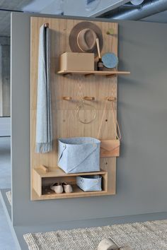 a wooden shelf filled with hats and other items on top of a carpeted floor