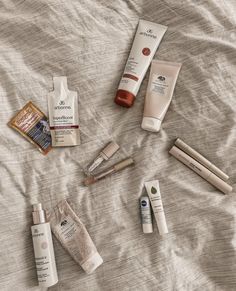 A few beauty products laying on a bedsheet. Arbonne Photography, Arbonne Advertising, Arbonne Products Pictures, Is Arbonne For You, Arbonne Daily Essentials Bundle, Independent Consultant, Holistic Wellness