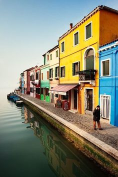 a row of colorful buildings next to the water