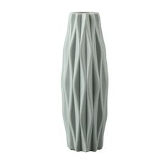 a tall white vase with wavy lines on the bottom and sides, sitting in front of a white background