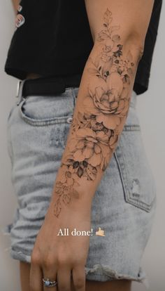 a woman with a flower tattoo on her arm