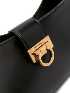 Trifolio shoulder bag from SALVATORE FERRAGAMO featuring adjustable shoulder strap, matte finish, gold-tone hardware, engraved logo, foldover top, main compartment, internal zip pocket and Gancini plaque. Size Info UNI Color Detail Black Made In Italy Material Calf Leather 100% Season One Fall-Winter Season Two Fall-Winter Product bags.. Brand Ferragamo Size And Fit Width 11,81 in / 30 cm Height 7,48 in / 19 cm Depth 2,76 in / 7 cm Handle 9,84 in / 25 cm Classic Everyday Flap Bag With Gold-tone Logo Plaque, Chic Business Shoulder Bag With Logo Plaque, Formal Crossbody Shoulder Bag With Logo Plaque, Modern Formal Bags With Logo Plaque, Modern Formal Bag With Logo Plaque, Elegant Rectangular Shoulder Bag With Logo Plaque, Rectangular Gold Shoulder Bag With Logo Plaque, Luxury Shoulder Bag With Logo Plaque And Top Handle, Timeless Rectangular Shoulder Bag With Gold-tone Logo