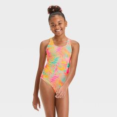 Help your kid create a fun and colorful swim outfit with the Leaf Printed One-Piece Swimsuit from art class™. This printed swimsuit is covered with tropical leaves and features a racerback style with keyhole detailing at the back for a stylish look. Made from soft and stretchy fabric with four-way stretch and full lining for comfortable wear, this swimsuit also has adjustable straps to help them find the perfect fit. Plus, it boasts a UPF 50+ rated design to help keep them shielded from harmful Swim Outfit, Rashguard Swimsuit, Girls Tie, Swimming Outfit, Wave Print, Tie Dye Designs, Girls Sweet, Kids Outfits Girls, Swimwear Fashion