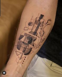 a man with a guitar tattoo on his arm