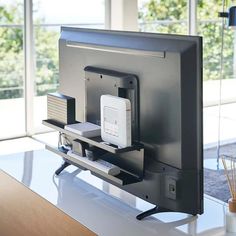 a flat screen tv sitting on top of a white table