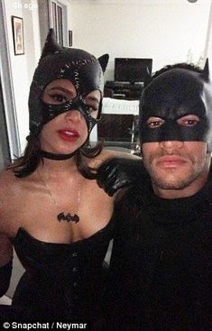 the man and woman are dressed up as batman and catwomans for halloween party