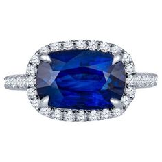 a blue sapphire and diamond ring set in 18k white gold