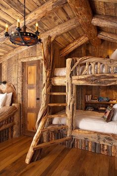 bunk beds made out of logs in a rustic cabin style bedroom with wood flooring