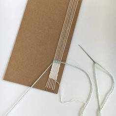 a piece of brown paper sitting on top of a white table next to some scissors