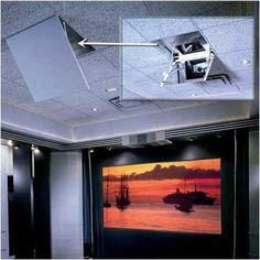 an overhead projector screen in the corner of a room with two pictures on it